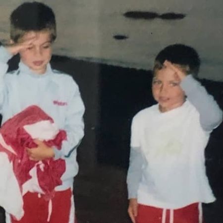 Harry Raftus and his brother during their childhood giving  salute in the picture